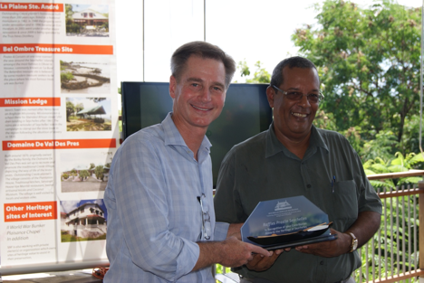 Mr. Simon Hirst the General Manager of Raffles Praslin Seychelles (left) receiving the trophy from Mr. Patrick Nanty Chief Executive Officer of Seychelles Heritage Foundation (right).